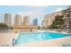 The community includes a pool with ample seating and is surrounded by lush landscaping at 205 E Harmon Ave # 212, Las Vegas, NV 89169