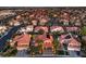Residential aerial showcasing the beautiful neighborhood, red-tiled roofs, palm trees and a peek of the city skyline at 2232 Barchetta Dr, Las Vegas, NV 89134