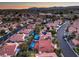 Drone view captures homes with swimming pools, manicured lawns, solar panels, and red tiled roofs in a picturesque neighborhood at 2232 Barchetta Dr, Las Vegas, NV 89134