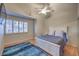 Bright bedroom featuring wood floors, a ceiling fan and large window with shutters at 2232 Barchetta Dr, Las Vegas, NV 89134