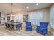 Elegant dining room with a modern chandelier, sleek table and natural light from windows with shutters at 2232 Barchetta Dr, Las Vegas, NV 89134