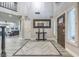 Spacious entryway with tile flooring, natural light, a dark wood front door and a soaring ceiling at 2232 Barchetta Dr, Las Vegas, NV 89134