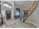 Inviting entryway with a soaring ceiling, wood-look tile flooring, staircase, and natural light from windows at 2232 Barchetta Dr, Las Vegas, NV 89134