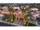 Exterior view showing a two-story home with lush landscaping, a three-car garage and well-maintained front yard at 2232 Barchetta Dr, Las Vegas, NV 89134