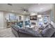 Inviting living room featuring a stone fireplace, plush seating, and access to the outdoor space at 2232 Barchetta Dr, Las Vegas, NV 89134