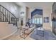 Open living room featuring high ceilings, natural light, a fireplace, and wood-look flooring at 2232 Barchetta Dr, Las Vegas, NV 89134