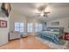 Spacious main bedroom with hardwood floors, ceiling fan, and comfortable seating area at 2232 Barchetta Dr, Las Vegas, NV 89134