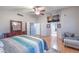 Bright primary bedroom with high ceilings, ceiling fan, television, and hardwood floors at 2232 Barchetta Dr, Las Vegas, NV 89134