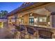 Covered patio with granite bar, ample seating, and outdoor lighting at 2232 Barchetta Dr, Las Vegas, NV 89134