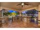 Outdoor kitchen with granite countertops, stainless steel grill, and bar seating at 2232 Barchetta Dr, Las Vegas, NV 89134