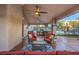 A luxurious covered outdoor living space featuring a built-in grill and ceiling fans at 2232 Barchetta Dr, Las Vegas, NV 89134