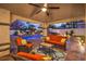 Covered patio with comfortable seating, outdoor rug, and view of the pool and waterfall at 2232 Barchetta Dr, Las Vegas, NV 89134