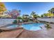 Beautiful pool and spa with rock waterfall feature and lush landscaping at 2232 Barchetta Dr, Las Vegas, NV 89134