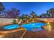 Resort-style pool and spa area with mature landscaping and a tranquil waterfall feature at 2232 Barchetta Dr, Las Vegas, NV 89134