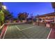 Illuminated sport court with basketball hoop and covered patio area for post-game relaxation and entertainment at 2232 Barchetta Dr, Las Vegas, NV 89134
