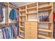 A very large walk-in closet with wood shelving, hanging clothes and drawers at 2232 Barchetta Dr, Las Vegas, NV 89134