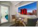 Cozy balcony seating area with a table and chairs, offering a picturesque view of the Las Vegas skyline at twilight at 2700 Las Vegas Blvd # 1301, Las Vegas, NV 89109