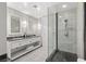 Bright bathroom features double vanity with granite countertop and glass-enclosed walk-in shower with marble tile at 2700 Las Vegas Blvd # 1301, Las Vegas, NV 89109