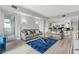 Bright, open-concept living room featuring hardwood floors, a modern kitchen, and comfortable gray couches at 2700 Las Vegas Blvd # 1301, Las Vegas, NV 89109