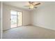 Spacious bedroom with ceiling fan and sliding door to the outdoor balcony at 2801 N Rainbow Blvd # 238, Las Vegas, NV 89108
