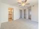 Cozy bedroom featuring a ceiling fan, carpet, and closet and ensuite bathroom access at 2801 N Rainbow Blvd # 238, Las Vegas, NV 89108