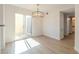 Bright dining area with modern light fixture and sliding glass doors leading outside at 2801 N Rainbow Blvd # 238, Las Vegas, NV 89108