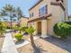 Inviting two-story tan home featuring a tiled roof and complemented by tidy landscaping at 2801 N Rainbow Blvd # 238, Las Vegas, NV 89108