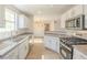 Open kitchen with stainless steel appliances, granite counters, and views to the living area at 2801 N Rainbow Blvd # 238, Las Vegas, NV 89108