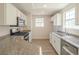 Bright kitchen features white cabinets, stainless steel appliances, and granite countertops at 2801 N Rainbow Blvd # 238, Las Vegas, NV 89108