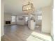 Spacious living area featuring an eat-in kitchen, fireplace, and modern light fixture at 2801 N Rainbow Blvd # 238, Las Vegas, NV 89108