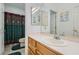 Well-lit bathroom featuring a shower-tub combo with patterned shower curtain and single sink vanity at 3290 Vicki Ave, Las Vegas, NV 89139