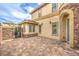 Side yard features stone accents, iron gate, and a brick-paved patio at 3725 Moonshine Falls Ave, North Las Vegas, NV 89085
