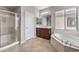 Bathroom featuring tile floor, a soaking tub, separate glass enclosed shower, and a vanity at 3725 Moonshine Falls Ave, North Las Vegas, NV 89085