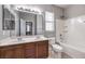 Bathroom with double sinks, large mirror, a shower and tub combo, and tile flooring at 3725 Moonshine Falls Ave, North Las Vegas, NV 89085