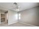 Well-lit carpeted bedroom with a window, ceiling fan, and easy access to the hallway at 3725 Moonshine Falls Ave, North Las Vegas, NV 89085