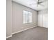 Neutral bedroom featuring plush carpeting, natural light from the window, and a ceiling fan at 3725 Moonshine Falls Ave, North Las Vegas, NV 89085
