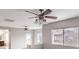 Bedroom with carpeted floors and ceiling fans is brightly illuminated with light from the windows at 3725 Moonshine Falls Ave, North Las Vegas, NV 89085