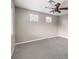 Bedroom features neutral walls, carpeted floors, ceiling fan, and large window with blinds at 3725 Moonshine Falls Ave, North Las Vegas, NV 89085