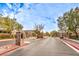 Elegant gated community entrance with stone pillars and well-maintained landscaping provides security and curb appeal at 3725 Moonshine Falls Ave, North Las Vegas, NV 89085