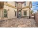Home exterior with stone accents, a curved entry, and a brick-paved driveway at 3725 Moonshine Falls Ave, North Las Vegas, NV 89085