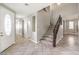 Spacious foyer with tile flooring and an elegant staircase leading to the upper level at 3725 Moonshine Falls Ave, North Las Vegas, NV 89085