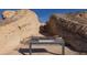 A sandstone rock formation is displayed with an information sign and desert landscape at 3725 Moonshine Falls Ave, North Las Vegas, NV 89085