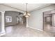 Inviting living room with a decorative chandelier, high ceilings, and easy access to other parts of the home at 3725 Moonshine Falls Ave, North Las Vegas, NV 89085