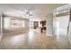 Large, open living room with ceiling fan, easy access to the kitchen, and views of the second story at 3725 Moonshine Falls Ave, North Las Vegas, NV 89085