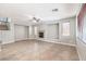 Open living room featuring a fireplace, tile flooring, and large windows allowing lots of natural light at 3725 Moonshine Falls Ave, North Las Vegas, NV 89085