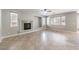 Open living room featuring a fireplace, tile flooring, and large windows allowing lots of natural light at 3725 Moonshine Falls Ave, North Las Vegas, NV 89085