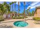 Inviting community pool featuring a luxurious in-ground hot tub, palm trees, and ample seating at 3725 Moonshine Falls Ave, North Las Vegas, NV 89085