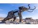 Intricate Ice Age mammal sculpture with the backdrop of a desert landscape and blue sky at 3725 Moonshine Falls Ave, North Las Vegas, NV 89085