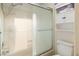 Bright bathroom with a shower over tub and sleek sliding glass door at 3740 Desert Marina Dr # 7, Laughlin, NV 89029