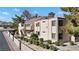 Exterior view of a condo building with balconies, lush landscaping, and community parking at 3740 Desert Marina Dr # 7, Laughlin, NV 89029